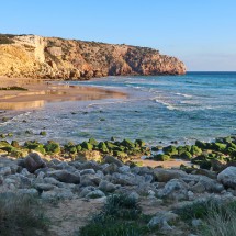 Beach Praia do Zavial with a lot of surfers in the water